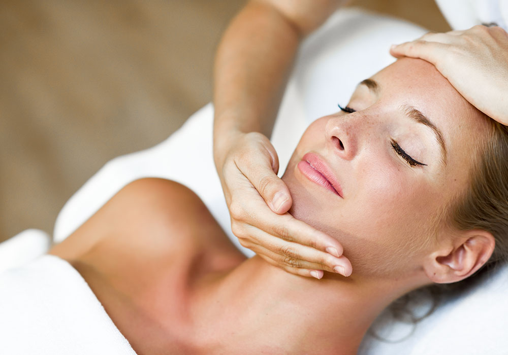 Young Woman Receiving A Head Massage In A Spa Center.