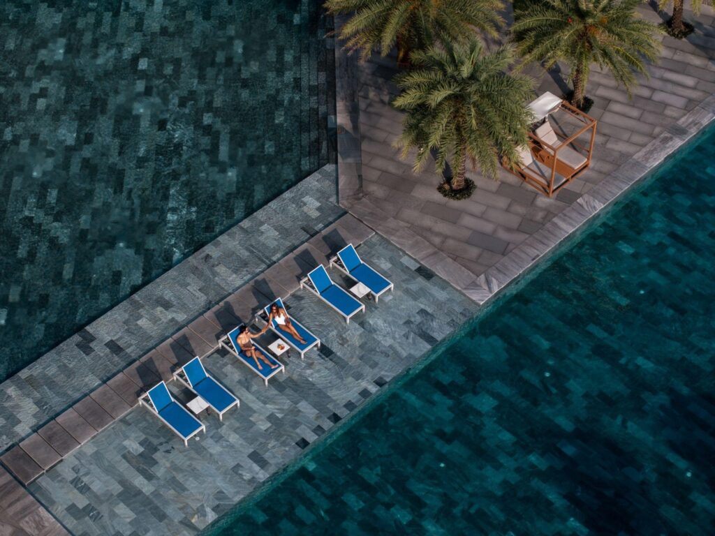 Two outdoor pools — a dramatic infinity pool overlooking the ocean, and a family pool complete with slides and water toys for the little ones